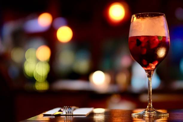 close up a glass of red cocktail on table.