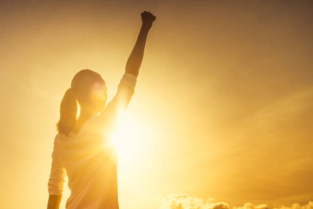 Woman power Woman with fist in the air at sunset. girl power photos stock pictures, royalty-free photos & images