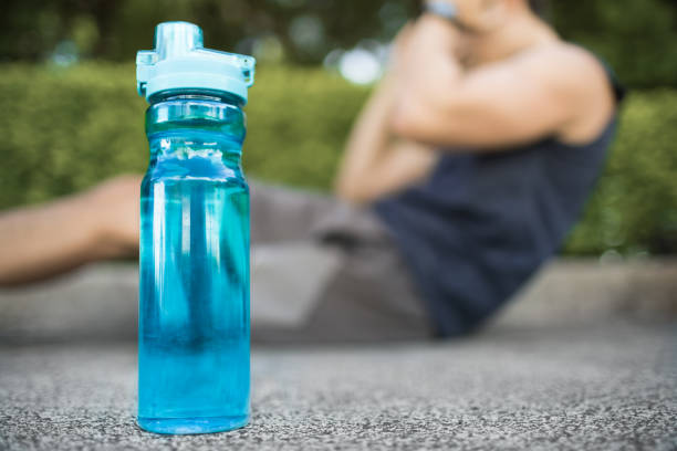 istock Man working out next to bottle of water. 1164225018