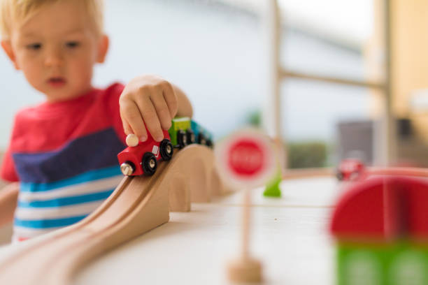 little boy playing with toy train. - block child play toy imagens e fotografias de stock