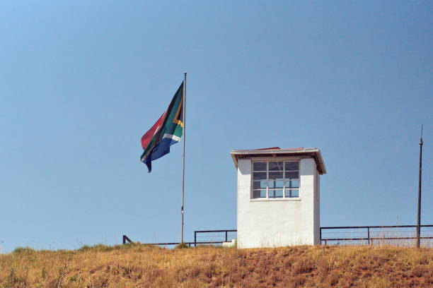 South African flag on Constitution Hill South African flag flying beside a guard post outside of the old prison museum on Constitution Hill in Johannesburg, South Africa pretoria prison stock pictures, royalty-free photos & images