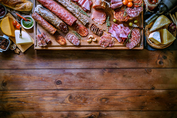 istock Tapas of cured ham and cheese delicious appetizer on rustic wood table with copy space 1164229564