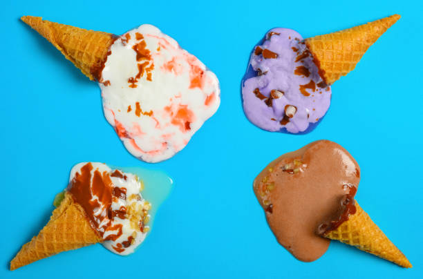 istock top view mini ice cream cones in a melting process on a blue background 1164229622