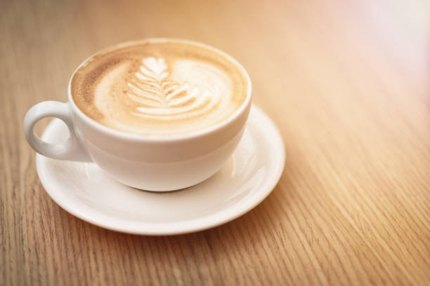 istock Hot coffee cappuccino latte art on wooden background 1164232568