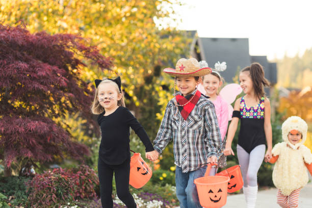istock Multiethnic group of kids trick or treating 1164234405
