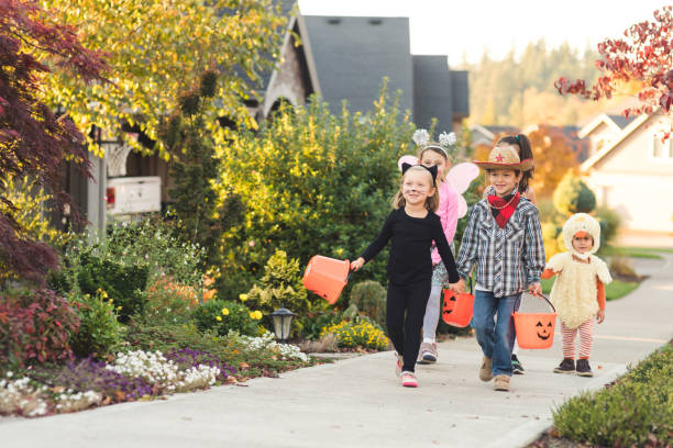 istock Multiethnic group of kids trick or treating 1164234406
