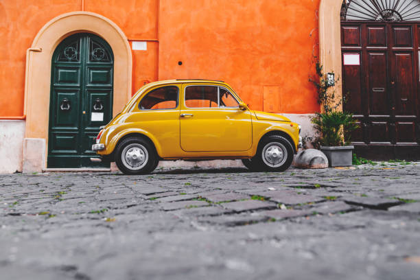 Cityscape and generic architecture from Rome, the Italian capital. Buggy car parked in the street.