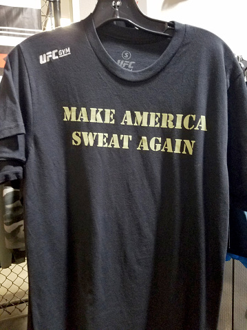 Honolulu - May 31, 2017:  'Make America Sweat Again' Shirt for sale at UFC Gym.  Parody shirt of Slogan 'Making America Great Again' or MAGA.