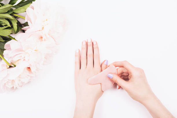 istock Gua sha massage jade tool in woman hands. 1164242176