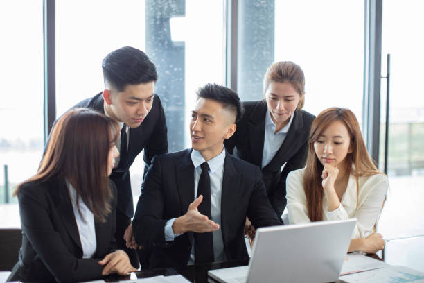 istock business people  looking at the laptop computer and talking during meeting 1164246574