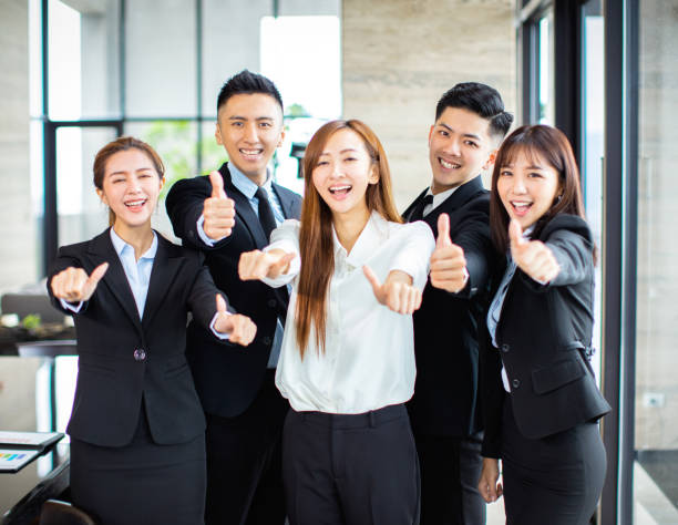 istock confident asian business team showing thumbs up 1164246577