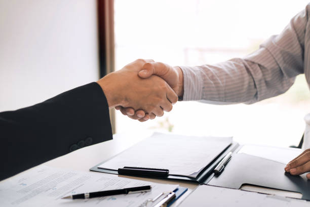 istock Manager and employee interview concept with handshake after talking about contract signing. 1164248796