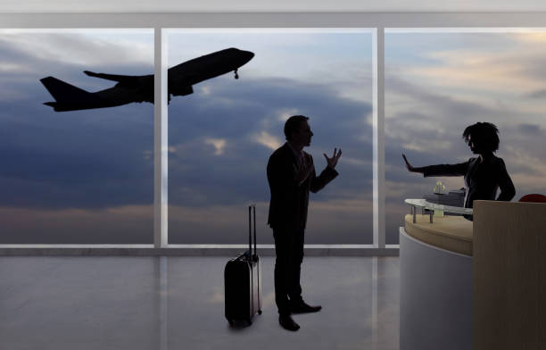 Stressed Out Passenger Arguing with Flight Attendant Stressed out businessman passenger arguing with a flight attendant or receptionist at an airport check in counter.  He is angry because of a delayed or cancelled flight. travel refund stock pictures, royalty-free photos & images