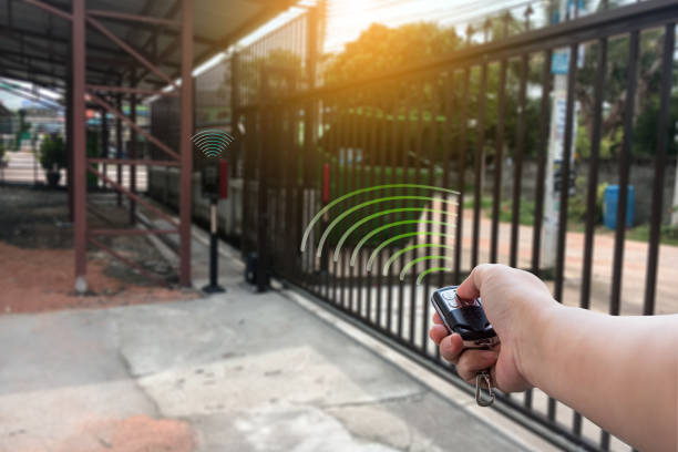 istock Signal of remote control when person open automatic gate at house with sunlight rays. 1164249476