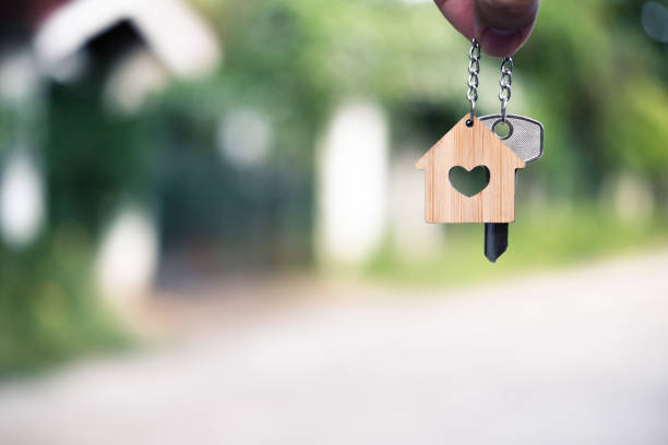 istock Home key with house keyring giving with blur house background, copy space 1164249999