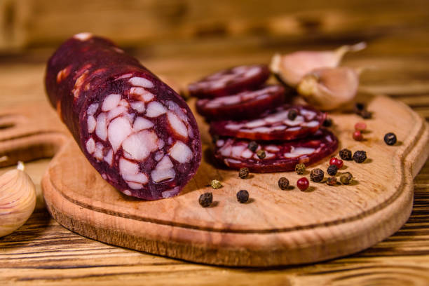 planche à découper avec la saucisse de salami tranchée et l'ail sur une table en bois - 7652 photos et images de collection