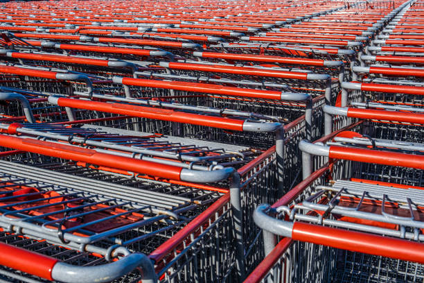 istock Rows of red shopping trolleys awaiting customers 1164254888