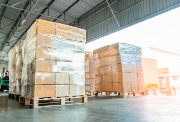 istock Warehouse and Logistics transportation, stacked of cardboard boxes or cargo shipment on pallets 1164255034