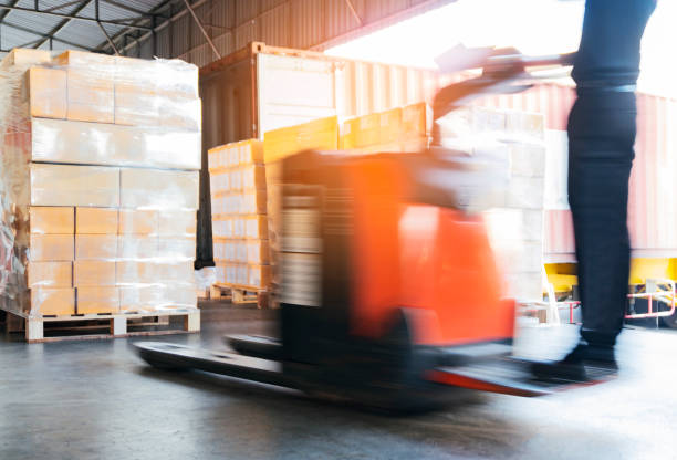 istock Motion blur of forklift driver unloading cargo pallets at warehouse 1164255747