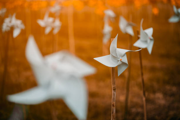 istock Paper windmills in green grass field.paper windmills. 1164255809