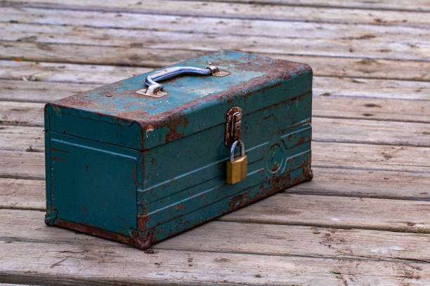 istock Rusty old toolbox locked up sitting on a wood 1164256788