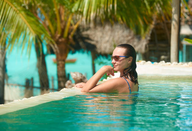 istock Attractive young woman relaxing in a spa's swimming pool. 1164264811
