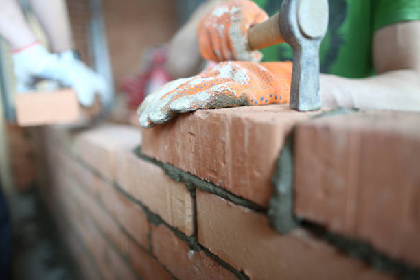 Careful man with hammer Close-up of skilled professional using special tools and equipment to make lasting concrete wall as perfect as possible. Builder wearing special gloves to protect arms. Building concept stacker stock pictures, royalty-free photos & images