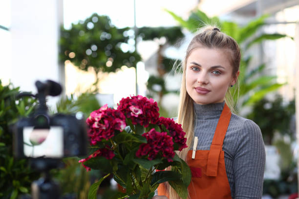 istock Beautiful Girl Blogger with Red Hydrangea Flower 1164268019