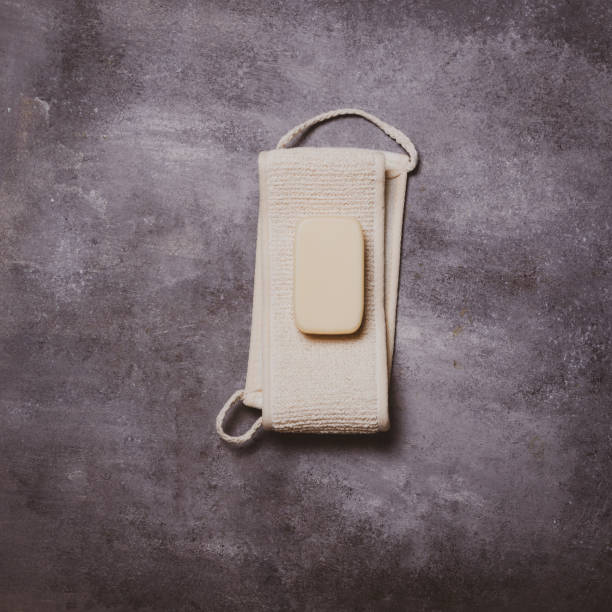 istock Washcloth with white soap on concrete background. 1164268596