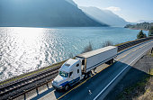 big-rig-semi-truck-transporting-cargo-in-refrigerator-semi-truck-running-on-the-road-along.jpg?b=1&s=170x170&k=20&c=1CMf_uw-Wa4OZDx5AxziVsuj8iGkrI2Ojr1UkBnG6WQ=