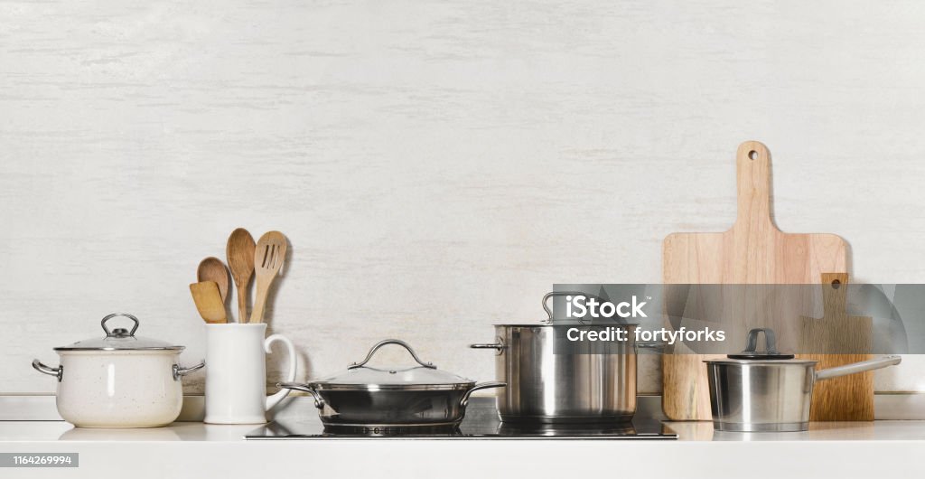 Kitchen utensils and stainless steel cookware Kitchen utensils and stainless steel cookware front view, space for a text above Cooking Pan Stock Photo