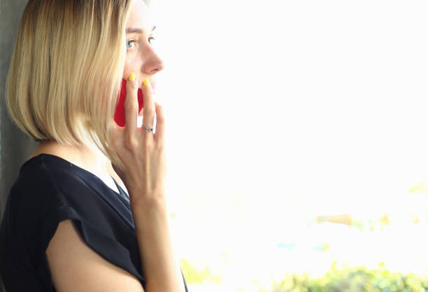 istock Pretty lady looking in window with joy 1164270387