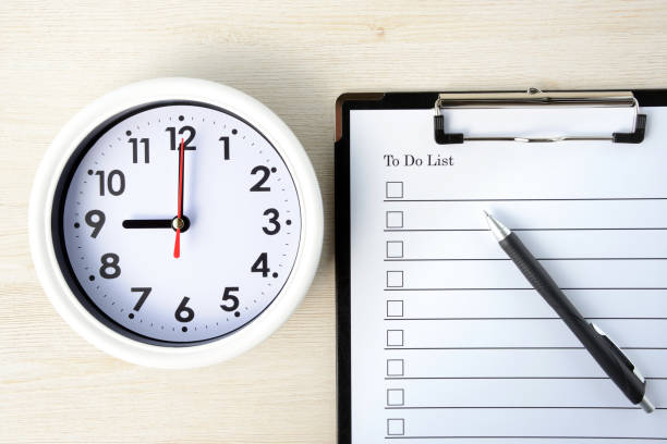 istock To do list and clock on wooden board 1164270888
