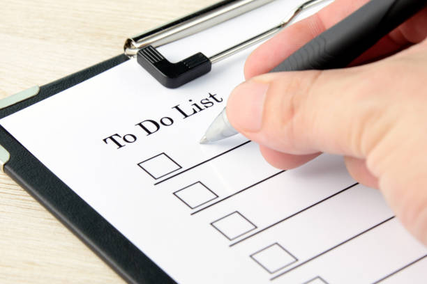 istock Business man writing on to do list 1164270890
