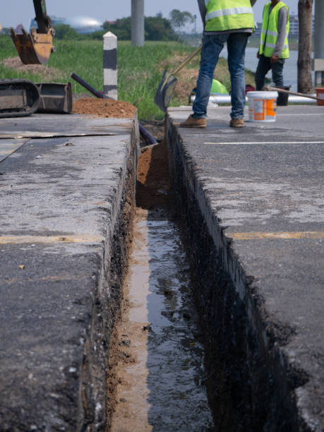 istock installing concrete drains on the side of the road 1164270957