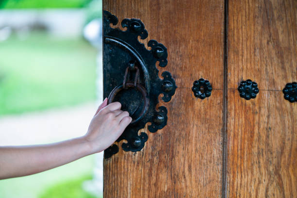 istock close up hand open Chinese wooden door 1164271004