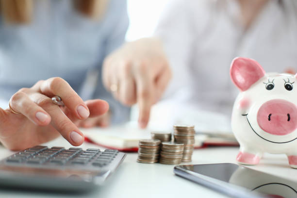 man and woman hand consider on calculator - debt crisis fotos imagens e fotografias de stock