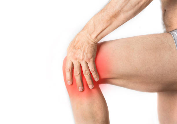 istock Man is holding his aching knee with a hand 1164273489