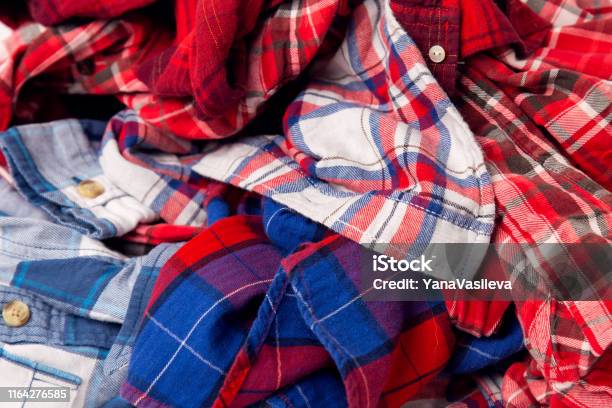 pile of men's colored clothes plaid shirts Stock Photo