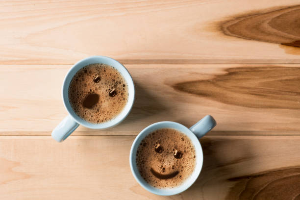 froth milk foam smiles in a cup of coffee in morning. stock photo