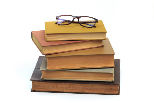 istock vintage old hardcover books with glasses on white background - Image 1164283813