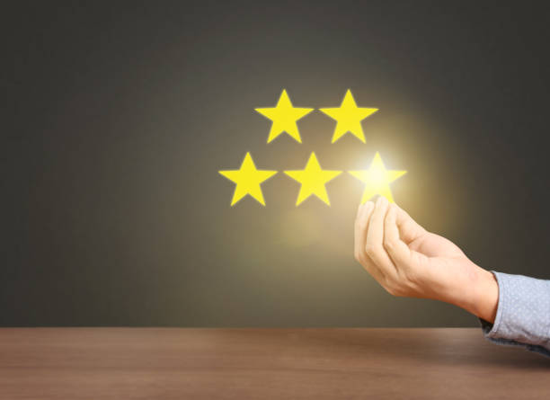 istock Hand touching five star symbol to increase rating 1164283860