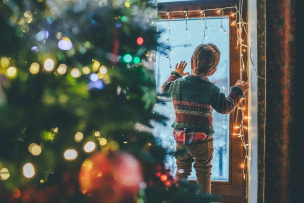 istock Little boy playing with Christmas lights at home 1164289232