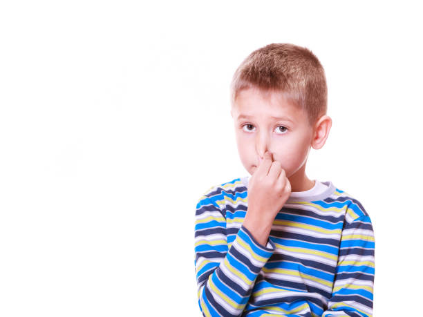 istock Little boy cover nose with fingers. 1164289837