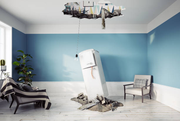 broken ceiling and falling refrigerator stock photo
