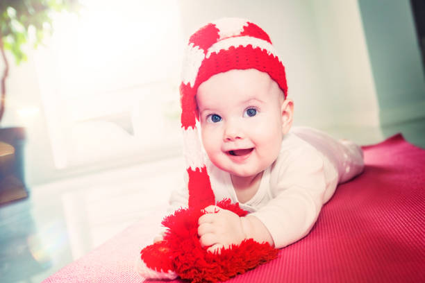 istock Smiling child in a red hat with a pompom. 1164293454