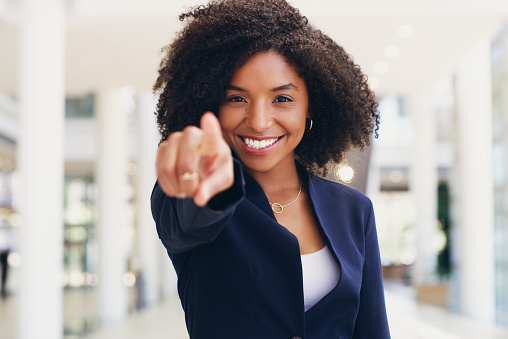 Cropped portrait of an attractive young businesswoman standing and pointing while in the office during the day