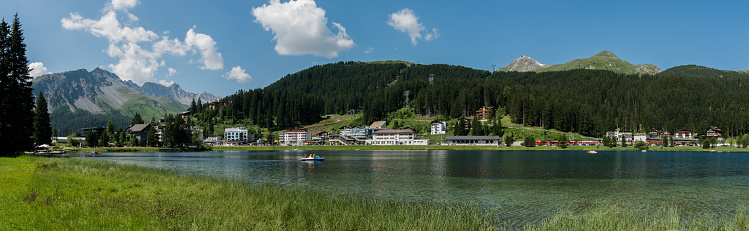 Arosa, GR / Switzerland - 24. July, 2019: panorama landscape view of the lake and town of Arosa in the Swiss Alps