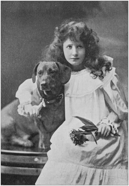 istock Antique photo: Little girl portrait with dog 1164301015