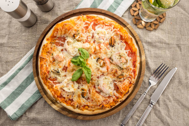 istock Pizza with seafood, mozzarella, mussels, octopus, squid, salmon, shrimp serves on the table 1164304042